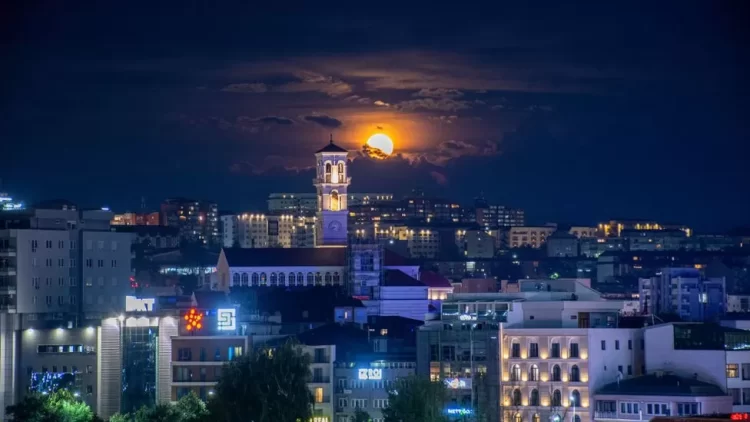 Tuesday's Sturgeon Moon, named after the increase in sturgeon fish in North American lakes at this time of year, glows over buildings in Pristina, Kosovo
